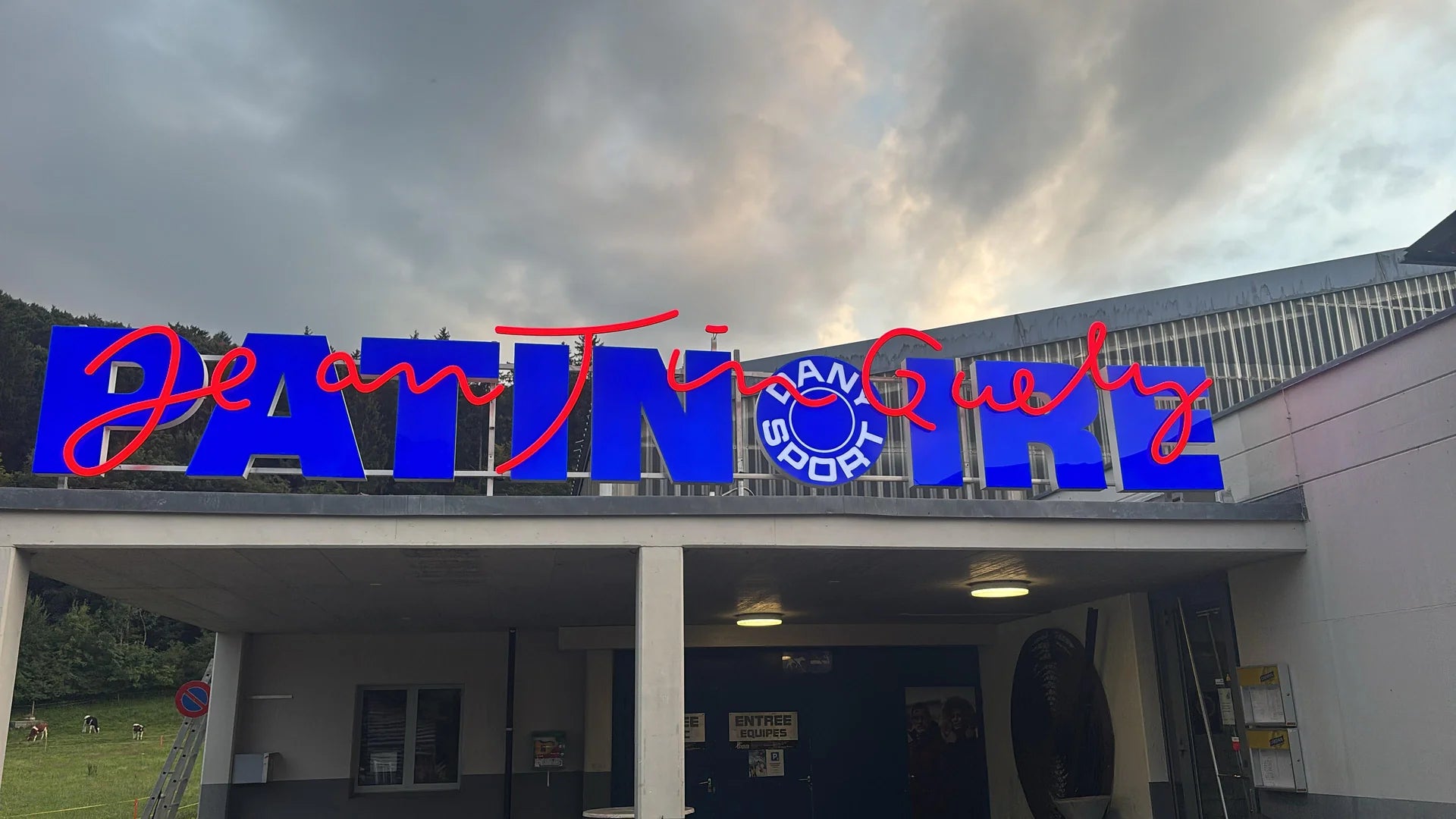 New illuminated PATINOIRE sign, Dany Sport logo and red Jean Tinguely script, installed in Marly, in the canton of Fribourg.