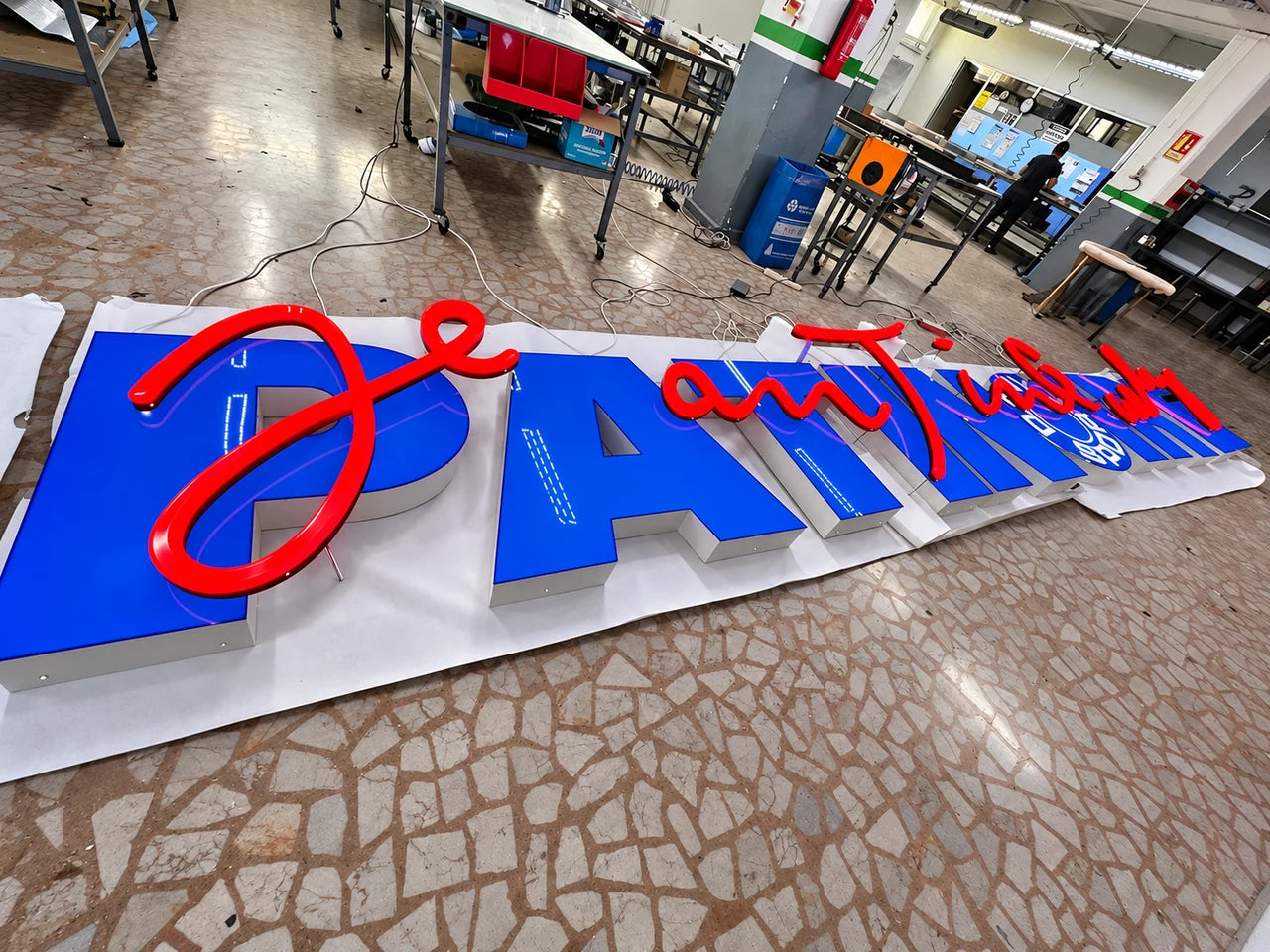 Authentic workshop photograph of the PATINOIRE Jean Tinguely sign during manufacture.