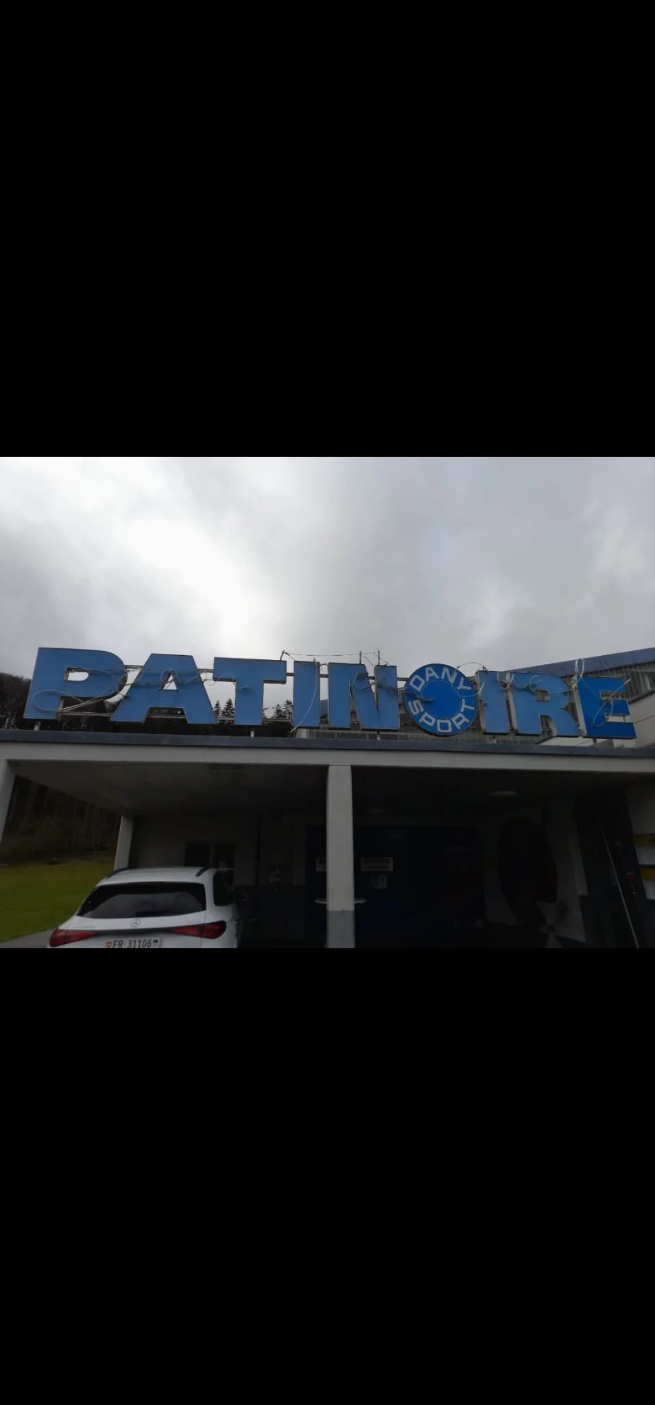 Original blue PATINOIRE sign with the Dany Sport logo before replacement in Marly, in the canton of Fribourg.
