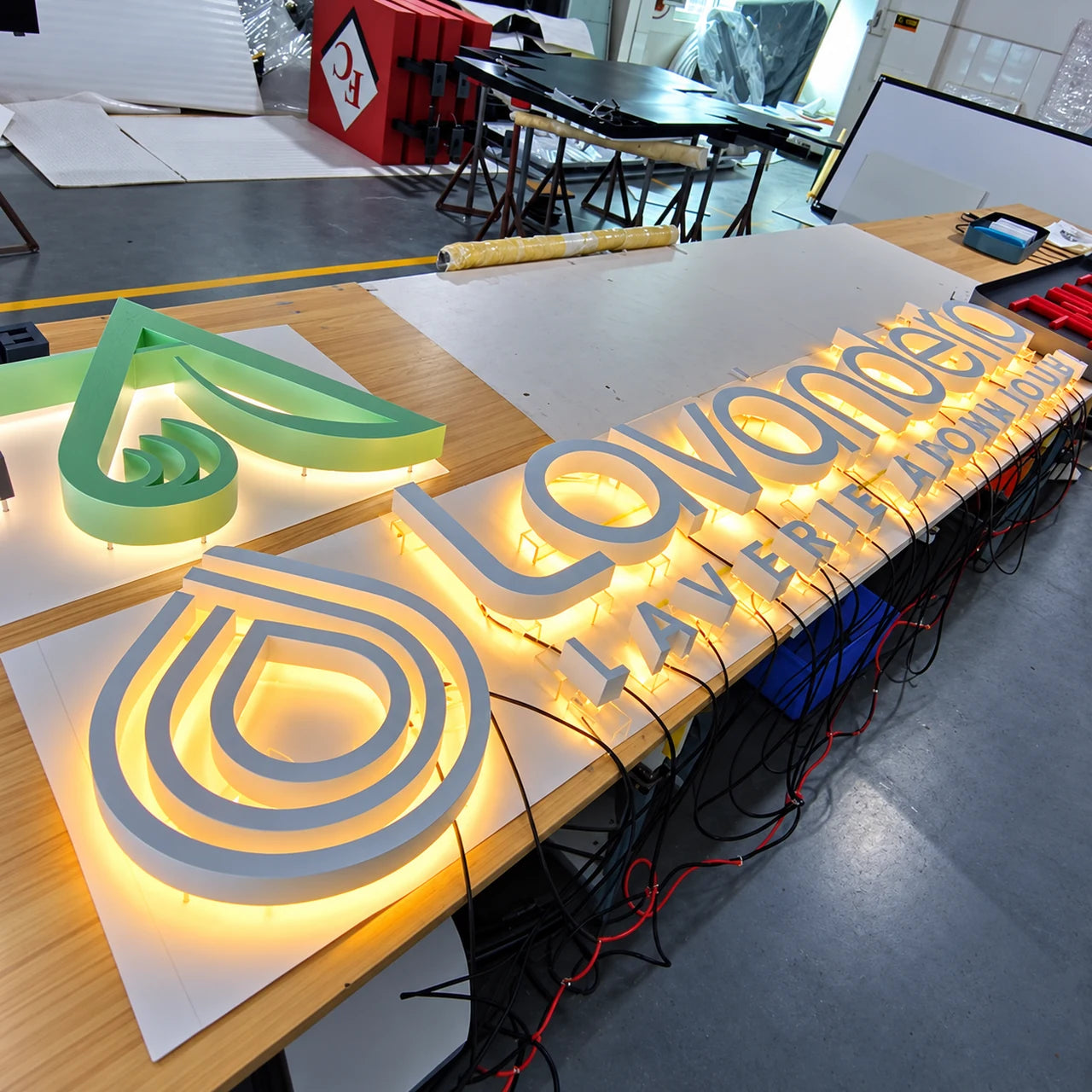 Authentic workshop photograph of the Lavanderia sign during manufacture.