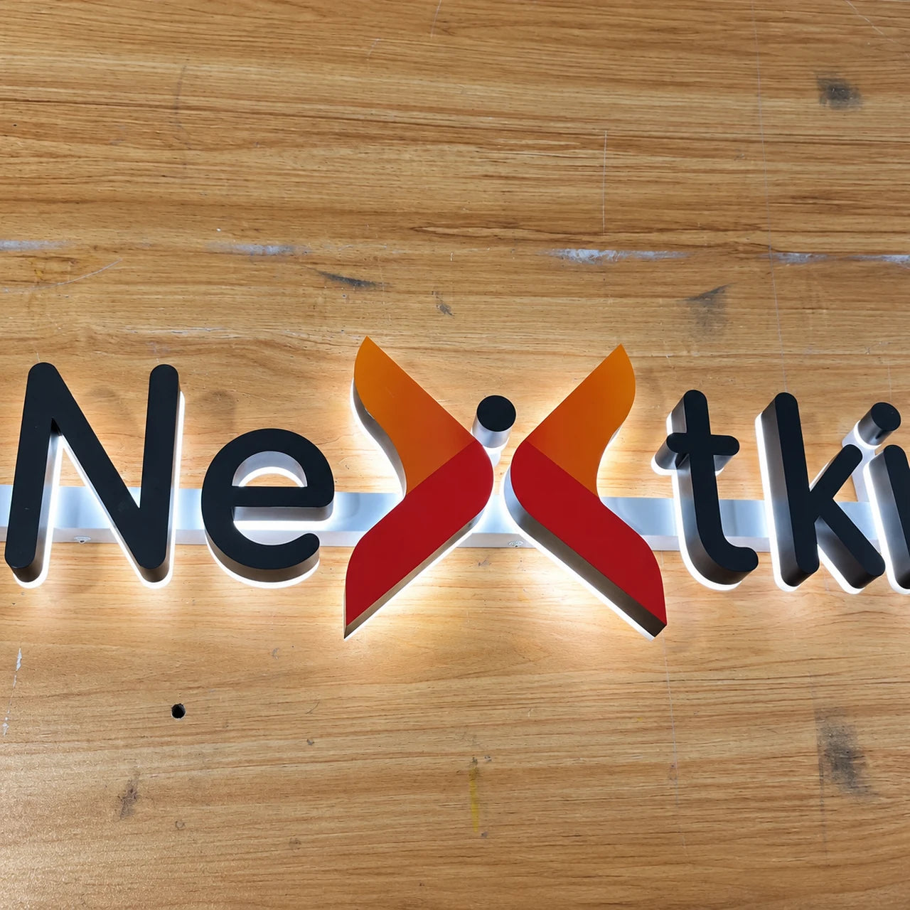Authentic workshop photograph of the Nextkidney sign during manufacture.